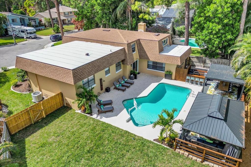 An aerial view of a two-story house with a swimming pool and a backyard gazebo — 14389 83RD PLACE, SEMINOLE, FL