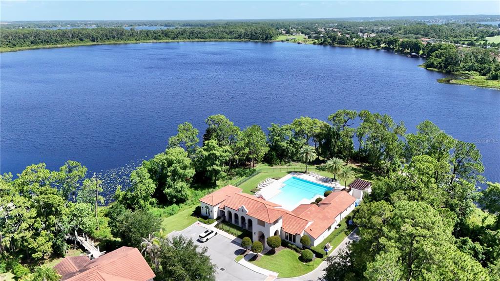 A single-story house with a white exterior, a blue front door, and a two-car garage — 10481 ROYAL CYPRESS WAY, ORLANDO, FL