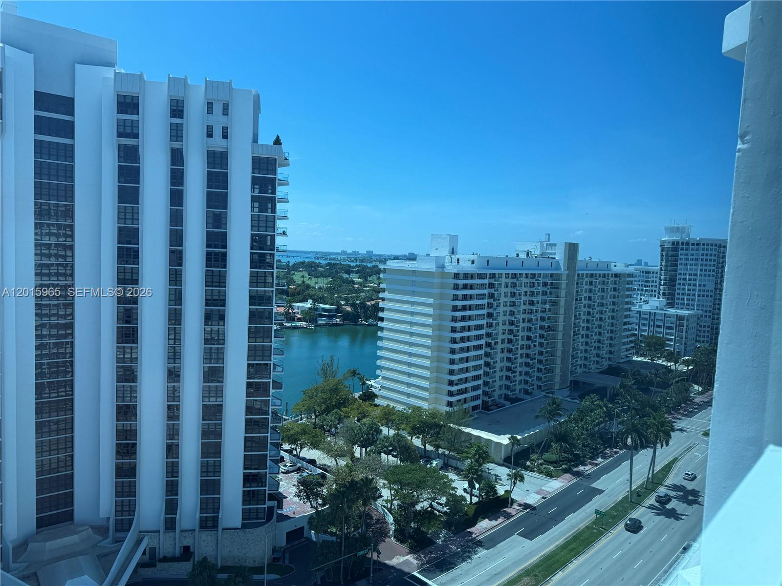 An elevated view shows high-rise apartment buildings overlooking a waterway and a road — 5445 Collins Ave # 1606, Miami Beach FL 33140, MIAMI BEACH, FL