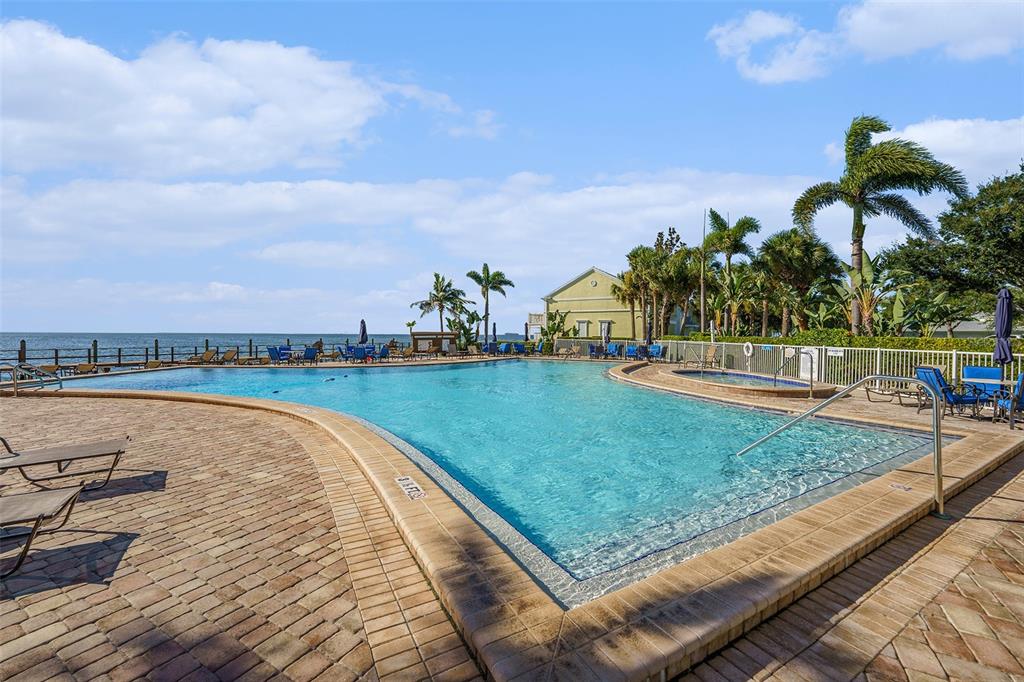 A two-story light blue building features a central entrance with a brick walkway — 5176 SALMON DRIVE SE UNIT A, ST PETERSBURG, FL