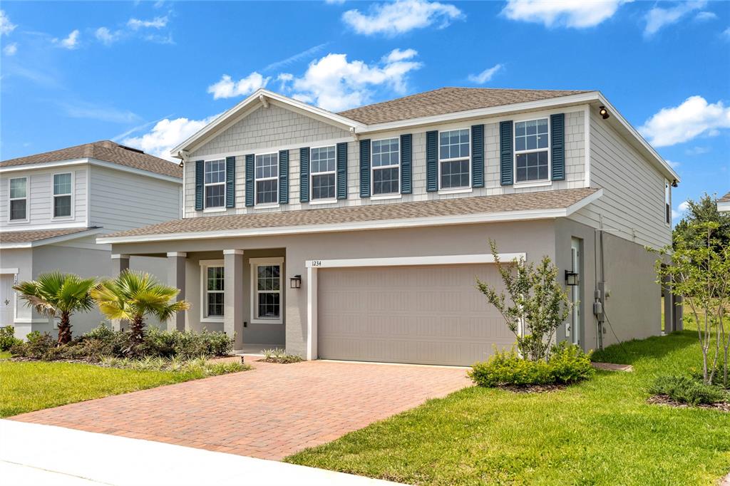 A home office features a wooden desk, two bookshelves, and framed artwork on a blue rug — 1234 WHISPERING LANE, MINNEOLA, FL