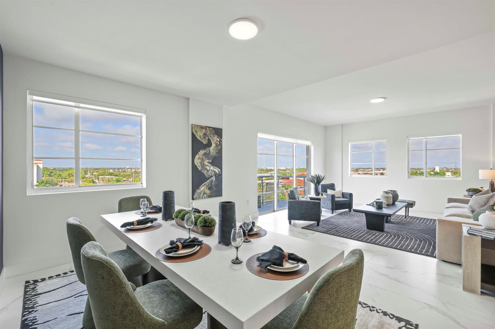 A bright, open-concept dining and living area features modern furniture, marble flooring, and large windows — 155 E Boca Raton Road # 823, Boca Raton FL 33432, BOCA RATON, FL
