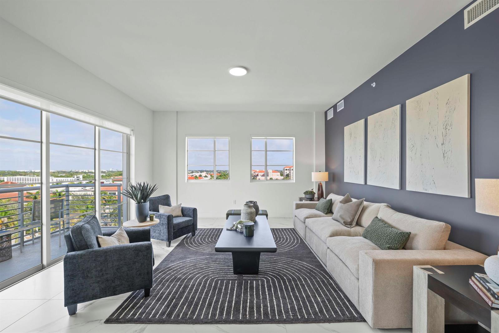 A modern living room features a beige sofa, dark armchairs, and a patterned area rug — 155 E Boca Raton Road # 823, Boca Raton FL 33432, BOCA RATON, FL