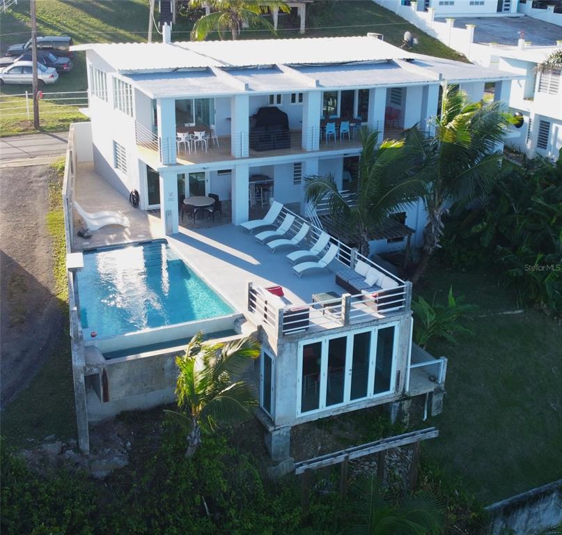 An aerial view of a two-story house featuring a swimming pool and a sun deck — 365 NORTH SHORE POINTE, VIEQUES, PR
