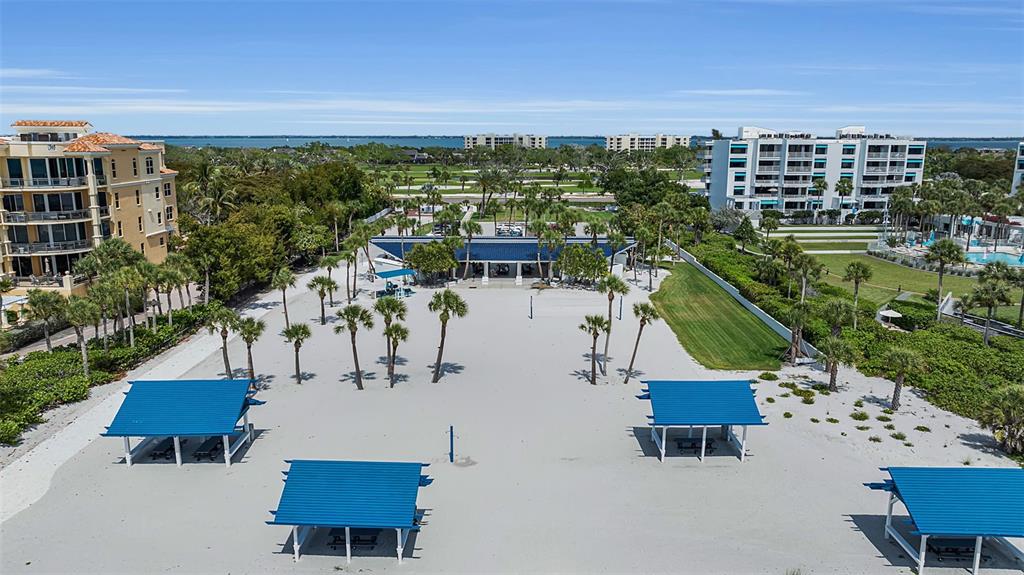 A bright dining and living area features tile floors, a glass table, and patio access — 1915 HARBOUR LINKS CIRCLE UNIT 6, LONGBOAT KEY, FL