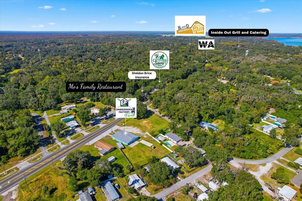 This aerial view shows a rural area with scattered buildings, a road, and business labels — 2339 N COUNTY 470 ROAD, LAKE PANASOFFKEE, FL