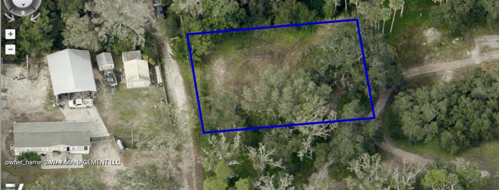 An aerial view shows a rectangular, wooded vacant lot outlined in blue next to houses — 792 ST CATHERINE AVENUE, CHRISTMAS, FL