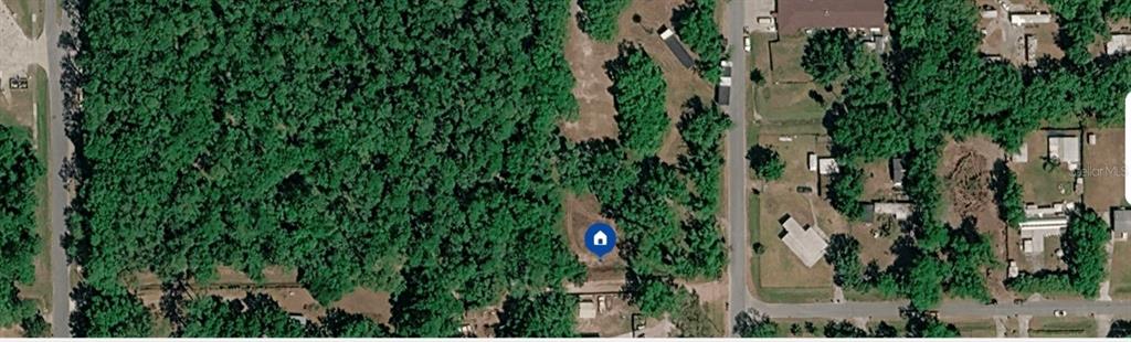 This aerial map shows a wooded lot with a blue house icon marker — 792 ST CATHERINE AVENUE, CHRISTMAS, FL