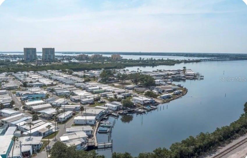 An aerial view shows a waterfront mobile home park with a boat dock and bridge — 167 4TH STREET W, PALMETTO, FL