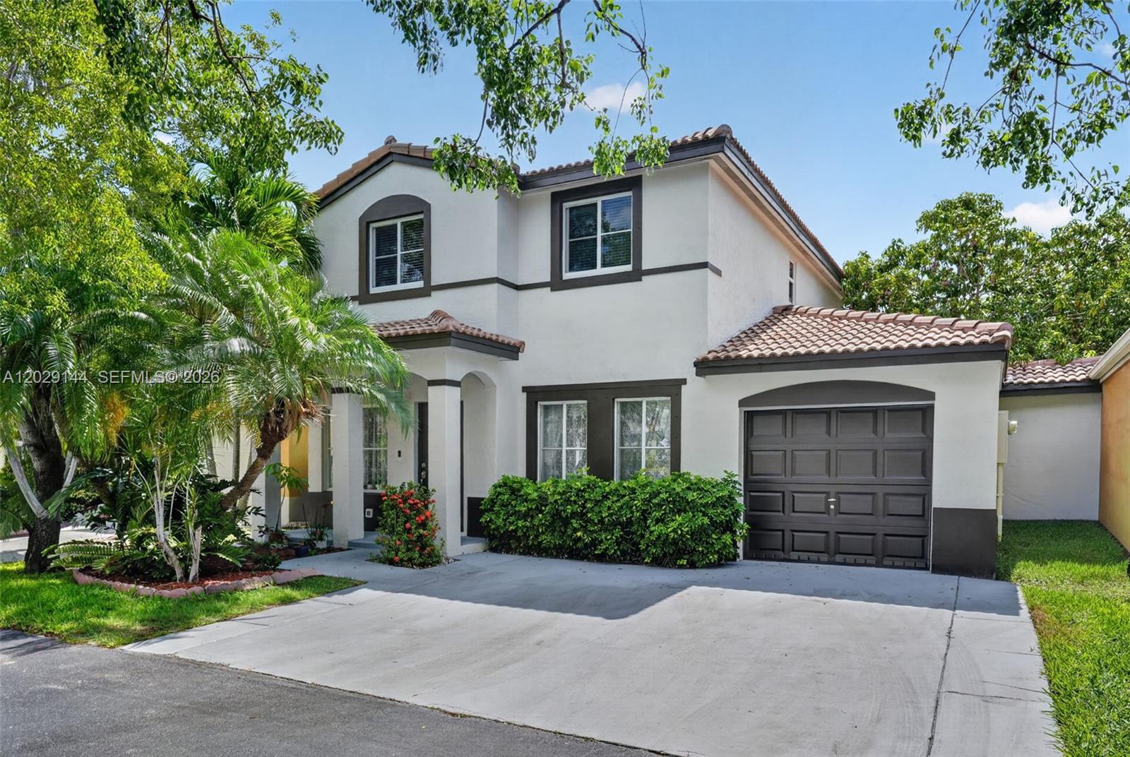 A two-story house with a white stucco exterior, dark trim, and a single-car garage — 9633 SW 163rd Ct, Miami FL 33196, MIAMI, FL