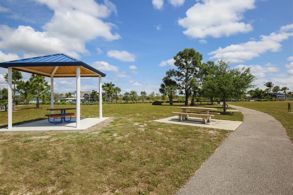 A park area features a covered picnic pavilion, an open-air picnic table, and a paved path — 13305 BLAKE DRIVE, PORT CHARLOTTE, FL
