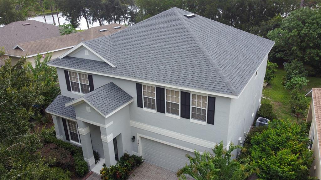 An aerial view of a two-story gray house with a shingled roof and garage — 3341 LAKE JEAN DRIVE, ORLANDO, FL