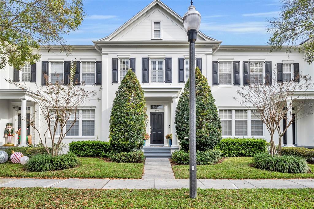 A white two-story townhouse with black shutters and a central front door — 995 JUEL STREET, ORLANDO, FL