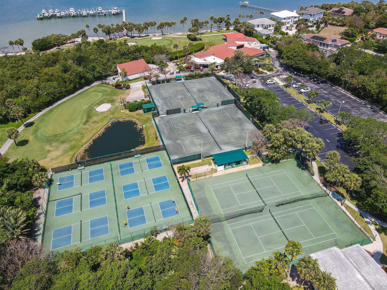 An aerial view shows multiple tennis courts, a small pond, and a parking lot — 8880 S Ocean Drive # 409, Jensen Beach FL 34957, JENSEN BEACH, FL