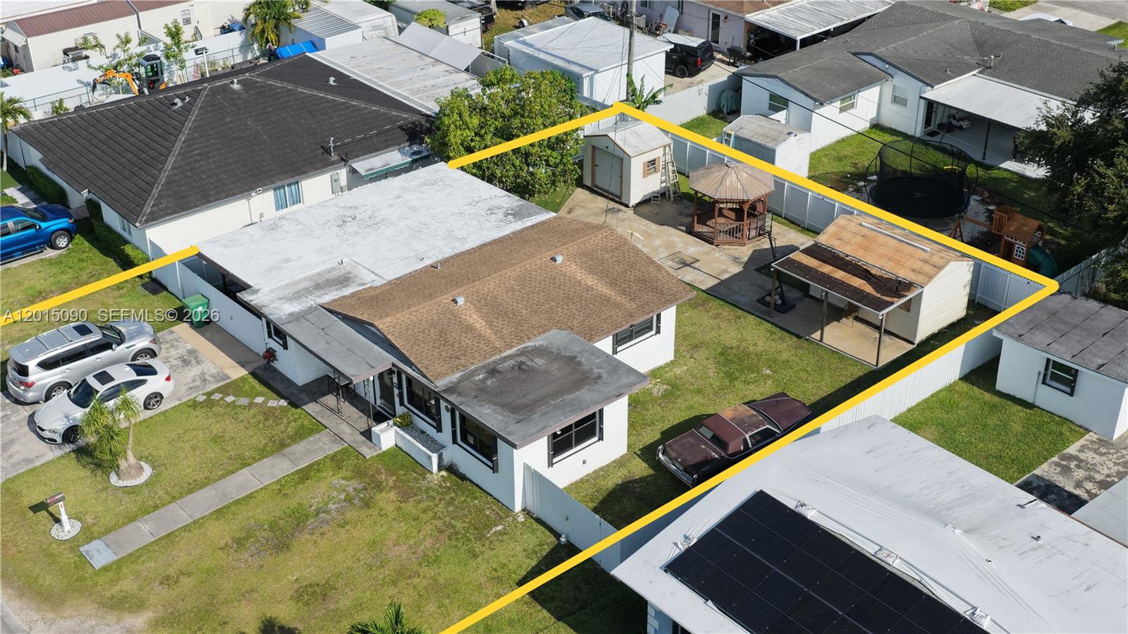 An aerial view shows a house with a fenced backyard, a shed, and a gazebo — 10955 SW 217th Ter, Miami FL 33170, MIAMI, FL
