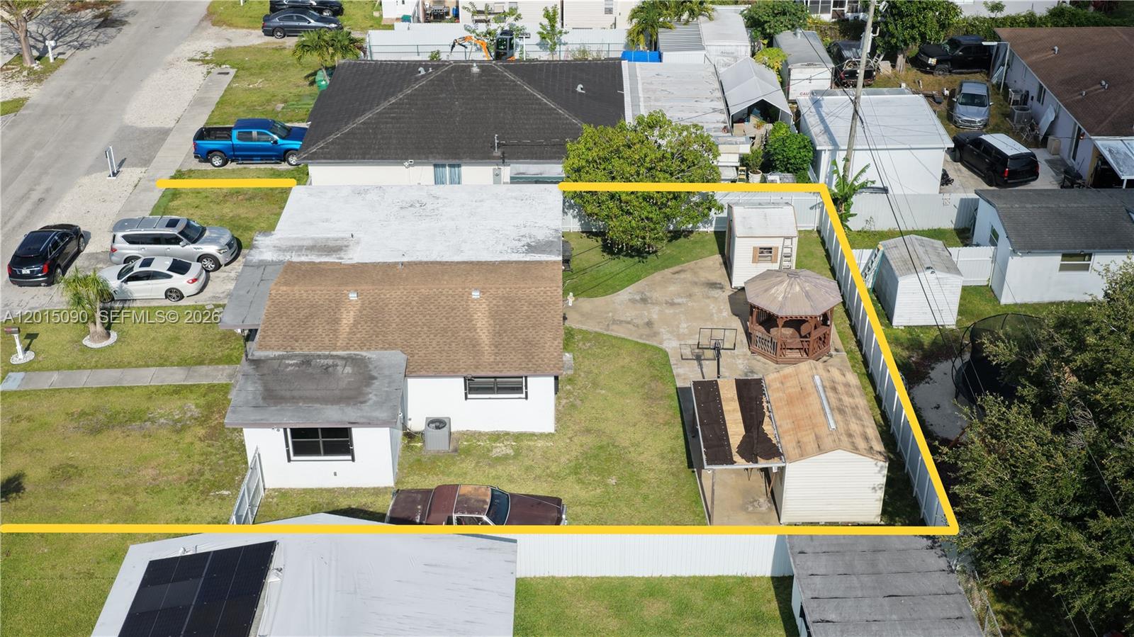 An aerial view shows a house with a yard, gazebo, shed, and multiple parked vehicles — 10955 SW 217th Ter, Miami FL 33170, MIAMI, FL