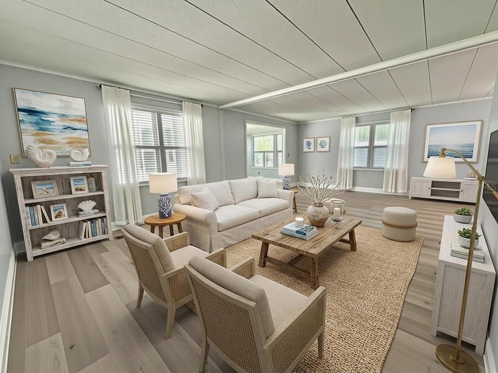A living room features light wood flooring, a beige sofa, two cane chairs, and coastal decor — 103 ROYAL PALM DRIVE, LEESBURG, FL