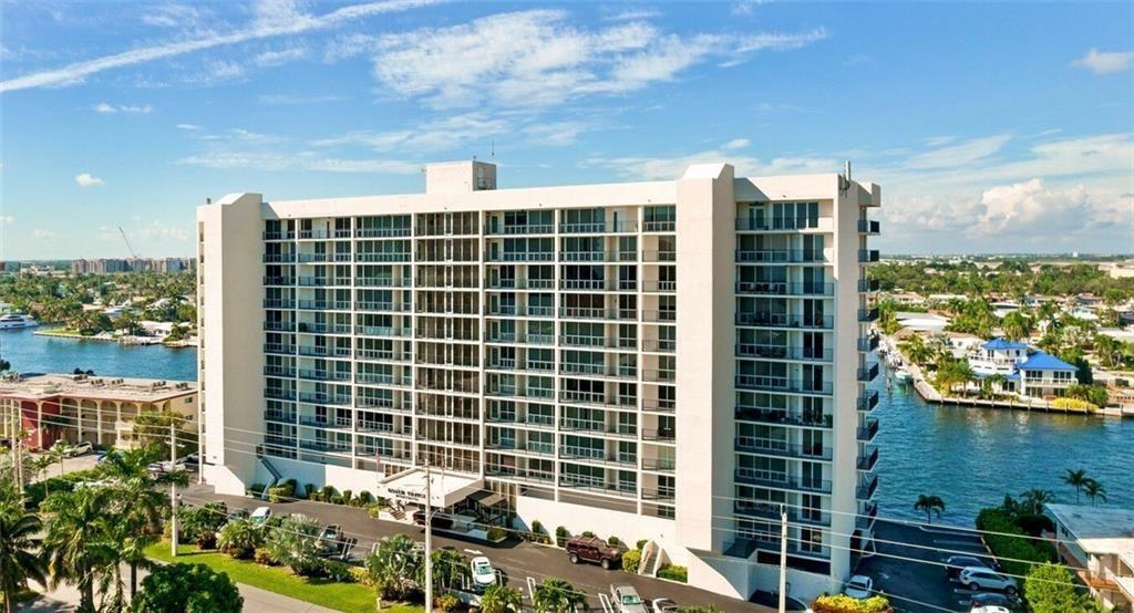 An aerial view of a tall, white residential building situated between two waterways — 521 N Riverside Drive # 602, Pompano Beach FL 33062, POMPANO BEACH, FL