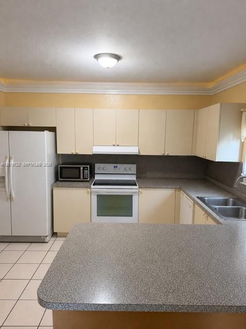 An empty room features yellow walls, white tile flooring, a white door, and a window — 14803 SW 9th Ln # 0, Miami FL 33194, MIAMI, FL
