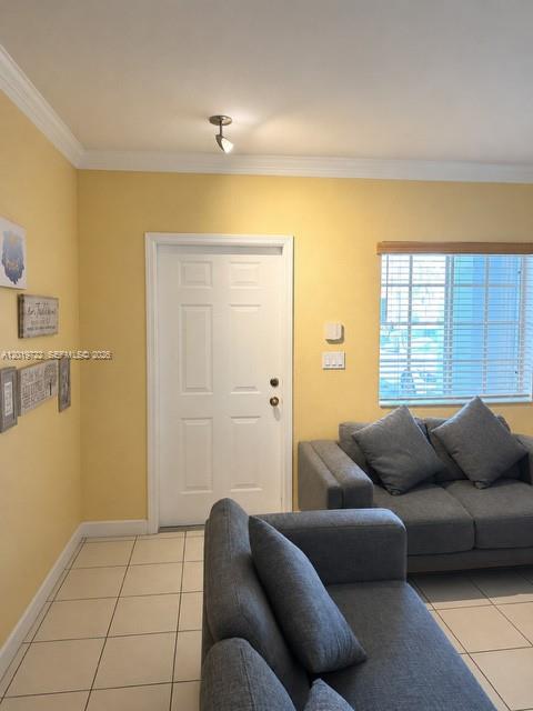 A kitchen features light-colored cabinets, a white refrigerator, a stove, and a gray countertop — 14803 SW 9th Ln # 0, Miami FL 33194, MIAMI, FL