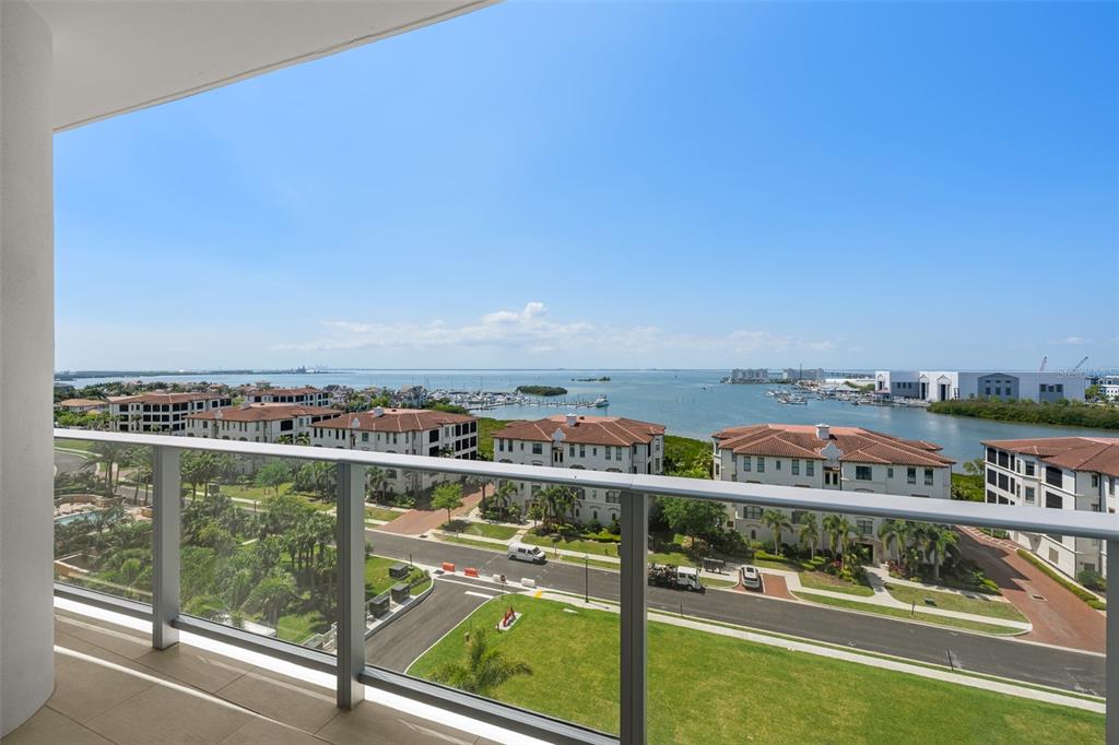A high-angle view from a balcony overlooking a coastal residential area and the ocean — 5713 BOWEN DANIEL DRIVE UNIT 903, TAMPA, FL