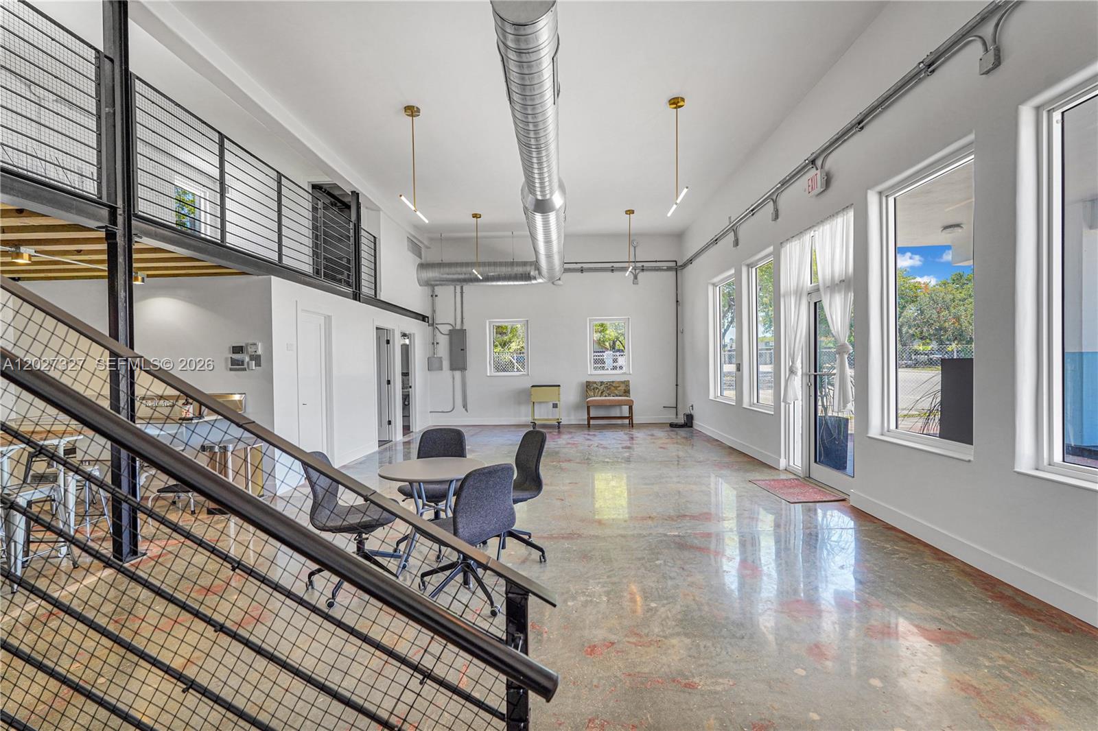 An industrial-style office space features a mezzanine, exposed ductwork, and polished concrete floors — 798 NW 62nd St, Miami FL 33150, MIAMI, FL