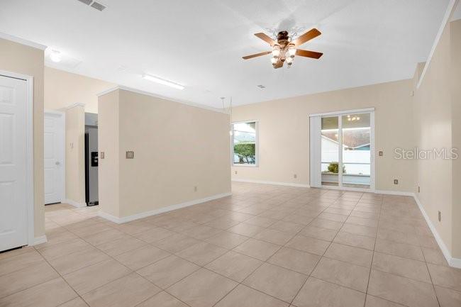 A bedroom features a queen bed, a wooden bench, two windows, and a ceiling fan — 213 MILL SLOUGH ROAD, OVIEDO, FL