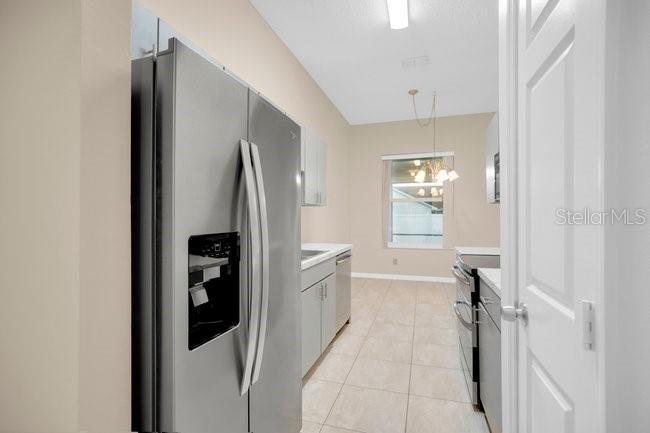 A bedroom features light walls, wood flooring, a ceiling fan, and a queen-sized bed — 213 MILL SLOUGH ROAD, OVIEDO, FL