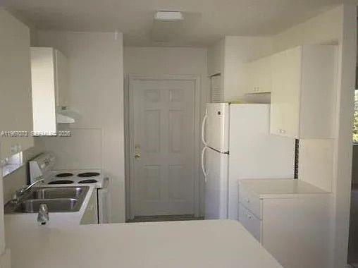 A kitchen with white cabinets, a white refrigerator, and a stainless steel sink — 937 SW 8th Pl, Florida City FL 33034, FLORIDA CITY, FL