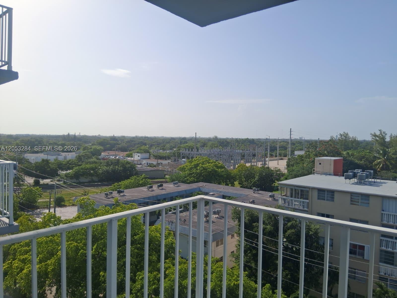 An elevated view from a balcony overlooking a residential area and an electrical substation — 1470 NE 125th Ter # 812, North Miami FL 33161, NORTH MIAMI, FL