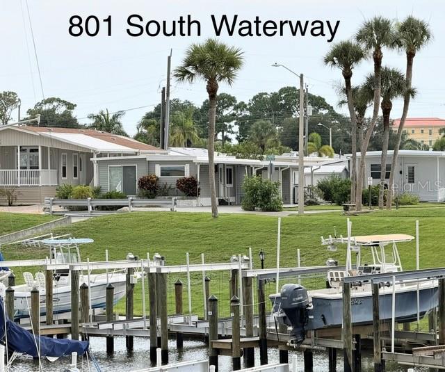 A view of boats docked at a canal in front of several manufactured homes — 801 S WATERWAY, VENICE, FL