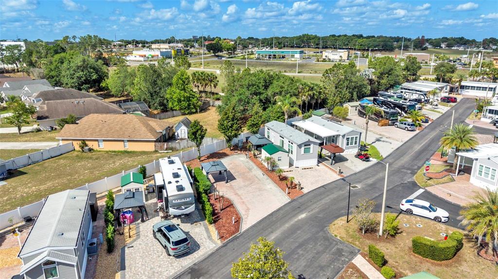 An aerial view shows a residential street with parked RVs, mobile homes, and paved driveways — 2320 LIMEWOOD AVENUE, CLERMONT, FL