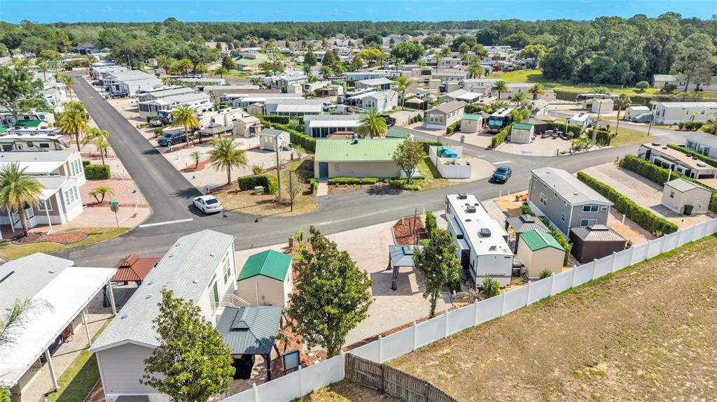 An aerial view shows a residential community with mobile homes, paved roads, and landscaped lots — 2320 LIMEWOOD AVENUE, CLERMONT, FL