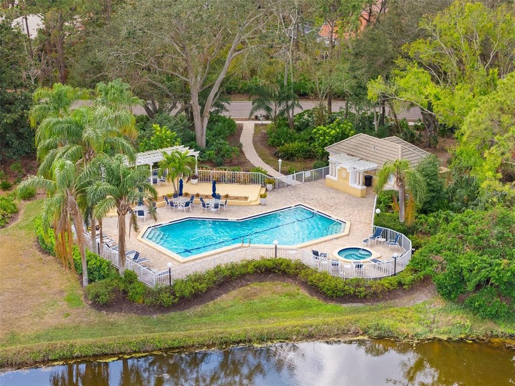The exterior of a single-story house features a tiled roof, light-colored walls, and a paved walkway — 6411 BERKSHIRE PLACE, UNIVERSITY PARK, FL
