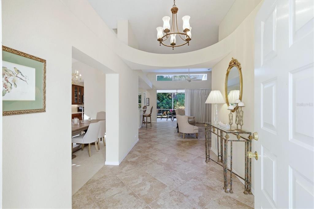 An aerial view shows a swimming pool and hot tub overlooking a large lake — 6411 BERKSHIRE PLACE, UNIVERSITY PARK, FL