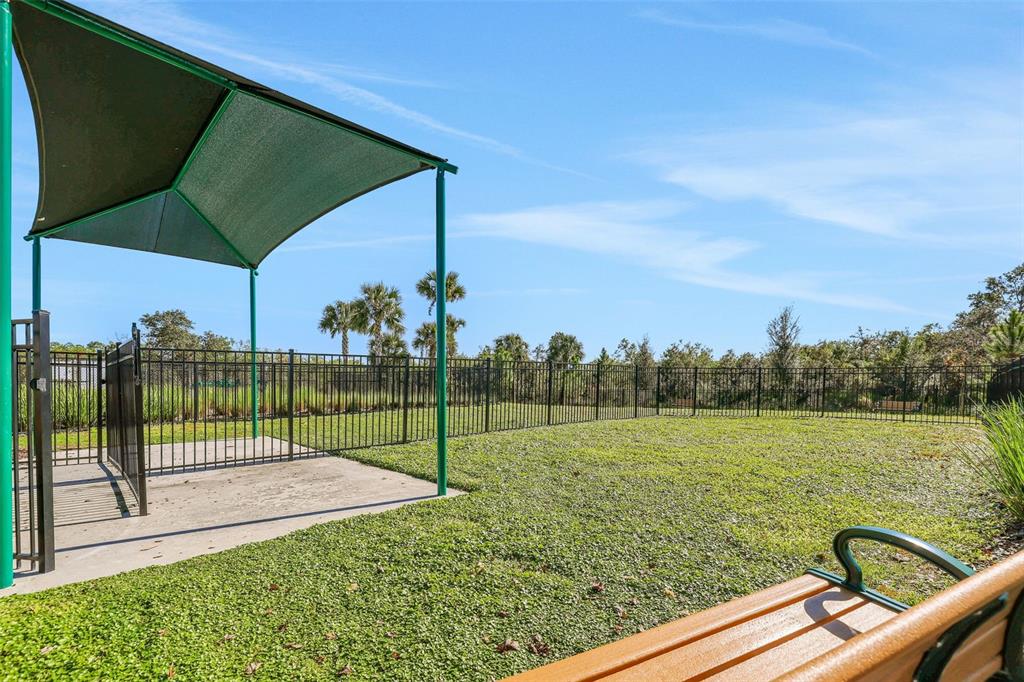 A two-story house with teal vertical siding, a front porch, and a blue front door — 13031 SERENE GLADE ROAD, WINTER GARDEN, FL