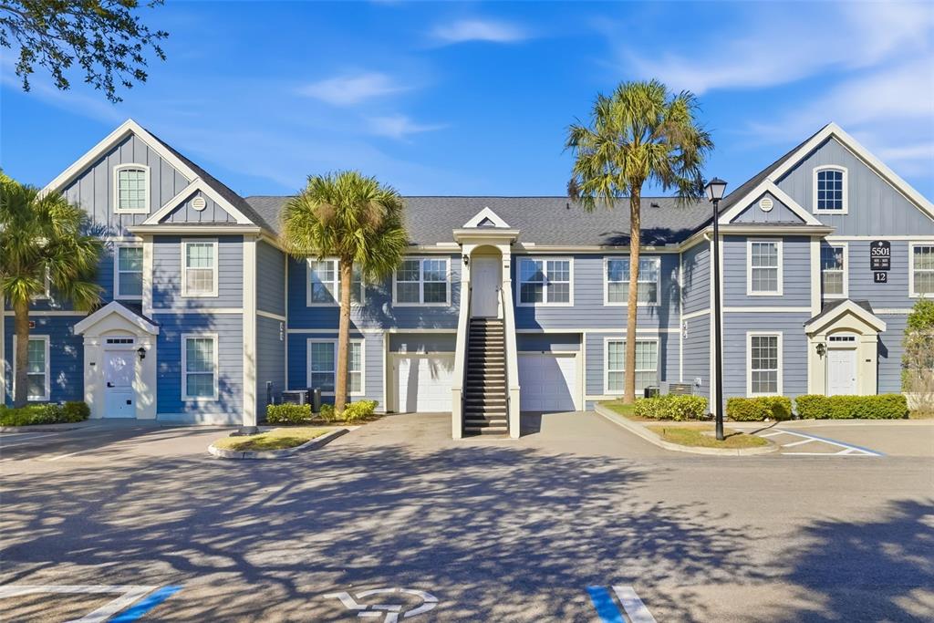 A two-story blue apartment building with white trim, palm trees, and a parking lot — 5501 ROSEHILL ROAD UNIT 103, SARASOTA, FL