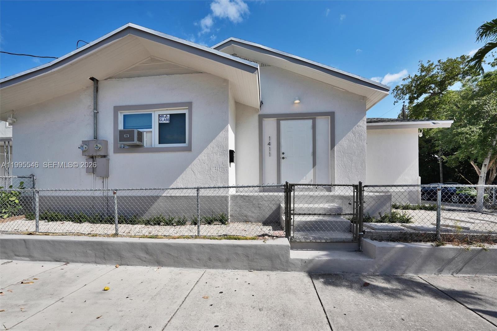 A white single-story house with a chain-link fence and a concrete front walkway — 1411 SW 3rd st # 2, Miami FL 33135, MIAMI, FL
