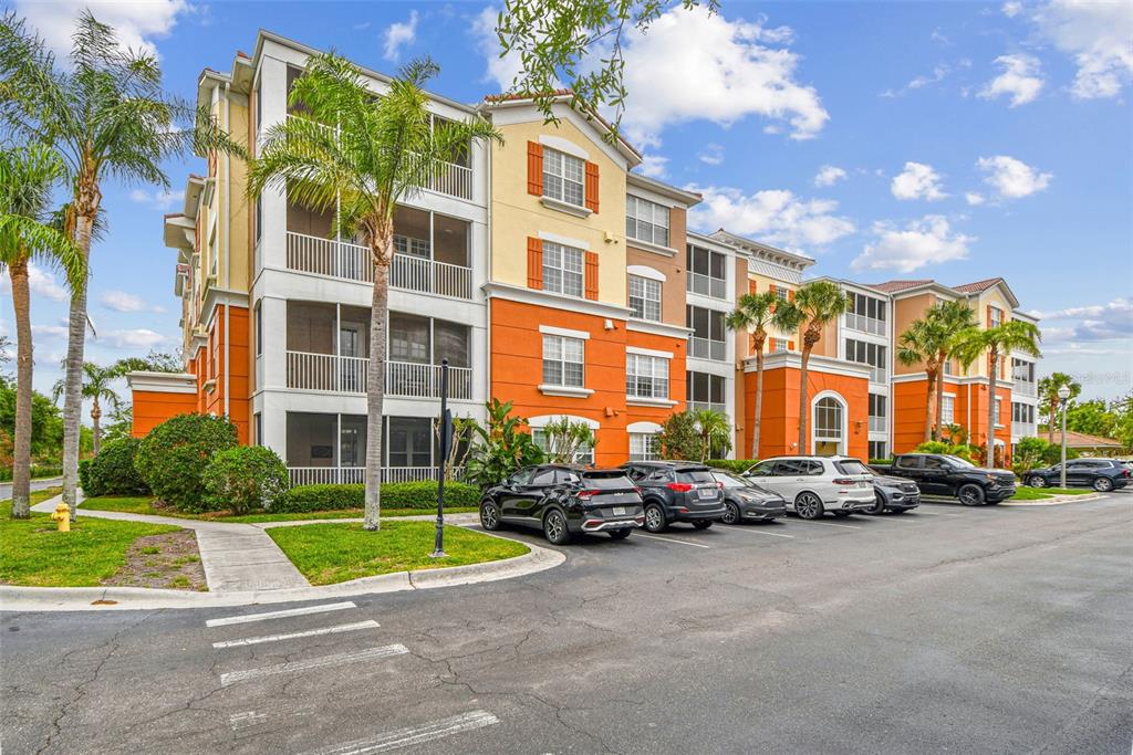 A multi-story apartment building with orange and yellow stucco walls and screened-in balconies — 7903 SEMINOLE BOULEVARD UNIT 2208, SEMINOLE, FL