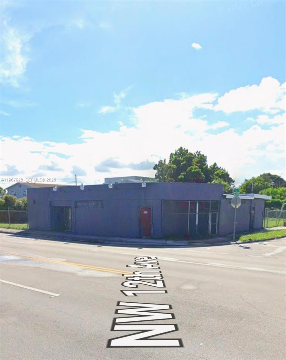 A single-story, purple-painted commercial building sits on a street corner — 1222 NW 59th St, Miami FL 33142, MIAMI, FL