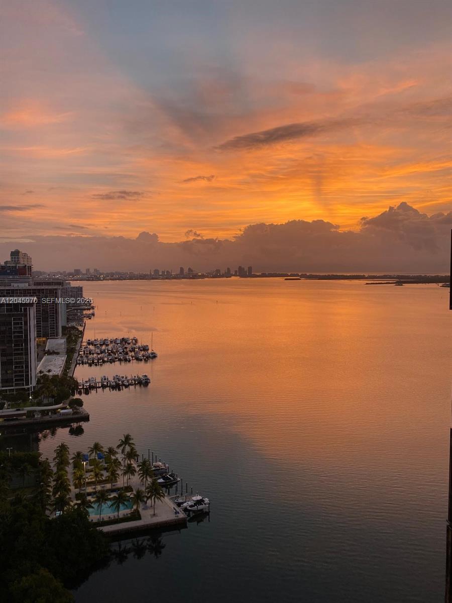 A high-angle view of a marina and bay at sunset with city buildings nearby — 2333 Brickell Ave, Miami FL 33129, MIAMI, FL