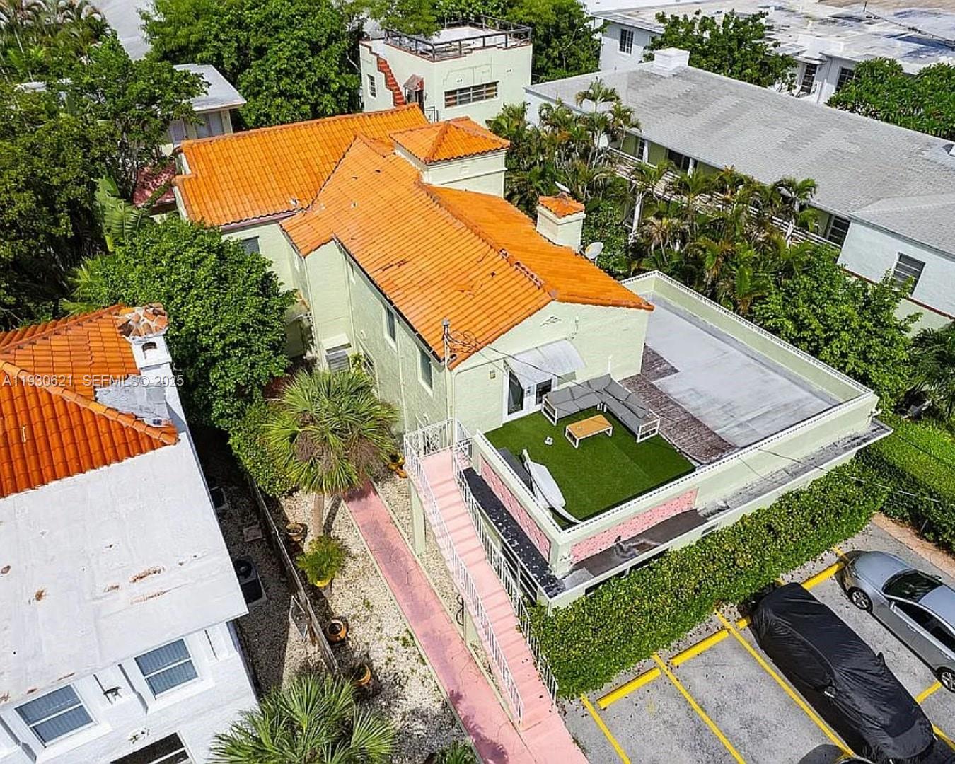 An aerial view of a two-story building with a tiled roof and a rooftop terrace — 2822 Pine Tree Dr, Miami Beach FL 33140, MIAMI BEACH, FL