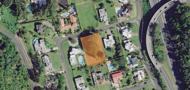 This aerial map shows a vacant, rectangular residential lot highlighted in orange within a neighborhood — B CONSTITUCION ST. EL RETIRO DEVELOPMENT LOT A-3, CAGUAS, PR