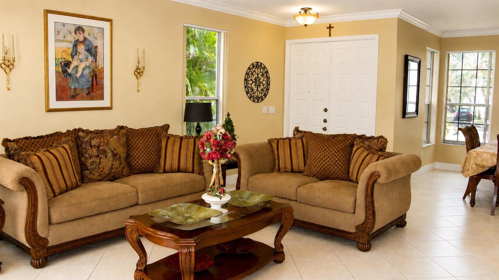 A living room features two brown sofas, a wooden coffee table, and tile flooring — 1802 SW 156th Avenue, Miramar FL 33027, MIRAMAR, FL
