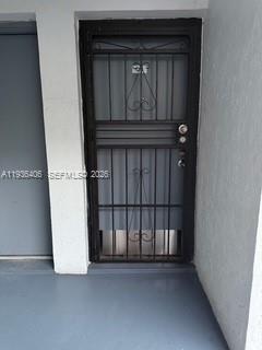 A black metal security screen door is installed on the exterior entrance of a building — 2460 SW 18th Ave # 1211, Miami FL 33145, MIAMI, FL