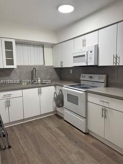A kitchen with white cabinets, stainless steel appliances, and wood-look flooring — 2460 SW 18th Ave # 1211, Miami FL 33145, MIAMI, FL