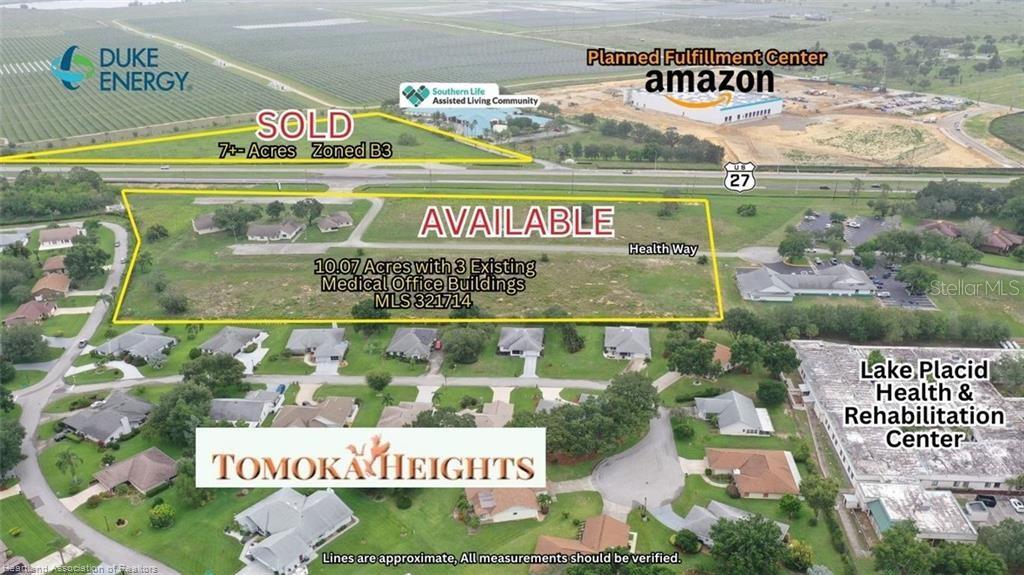 This aerial view shows a land parcel for sale with existing buildings near a highway — 1346 US 27 HIGHWAY N, LAKE PLACID, FL