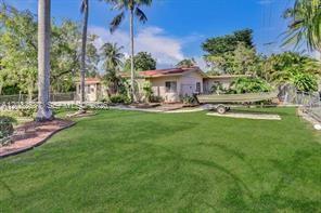 A single-story house with a boat on a trailer parked on the front lawn — 2199 NE 182nd St # 1, North Miami Beach FL 33162, NORTH MIAMI BEACH, FL