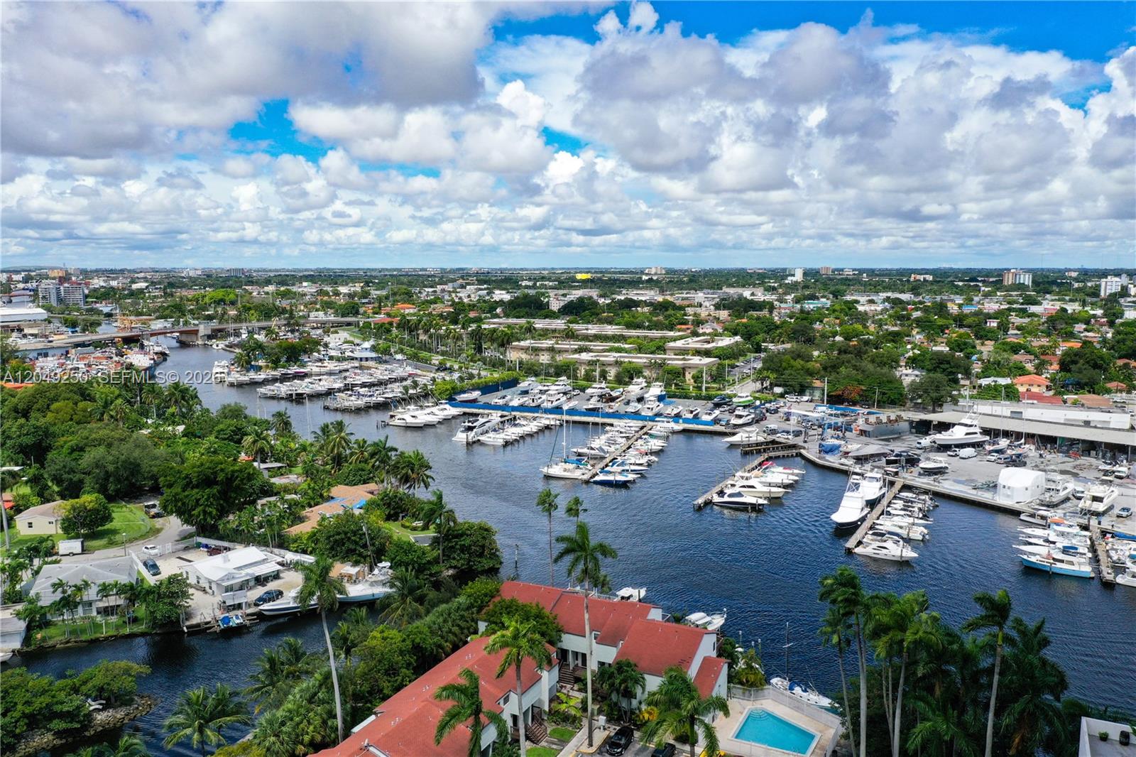 An aerial view shows a marina filled with boats next to residential buildings and trees — 1871 NW S River Dr # 1804, Miami FL 33125, MIAMI, FL