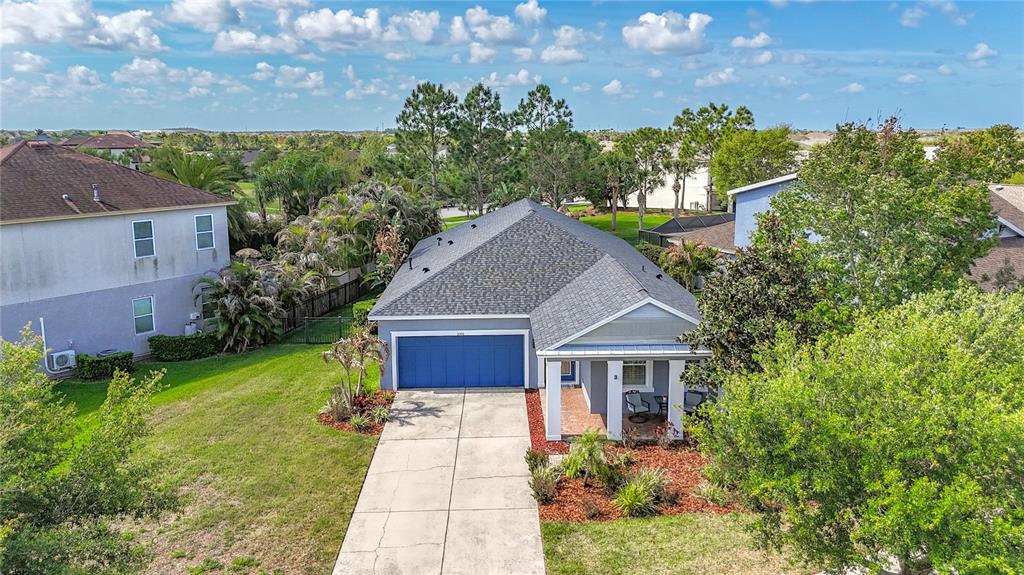 An aerial view of a single-story house with a blue garage and a front porch — 6506 NESTALL COURT, APOLLO BEACH, FL